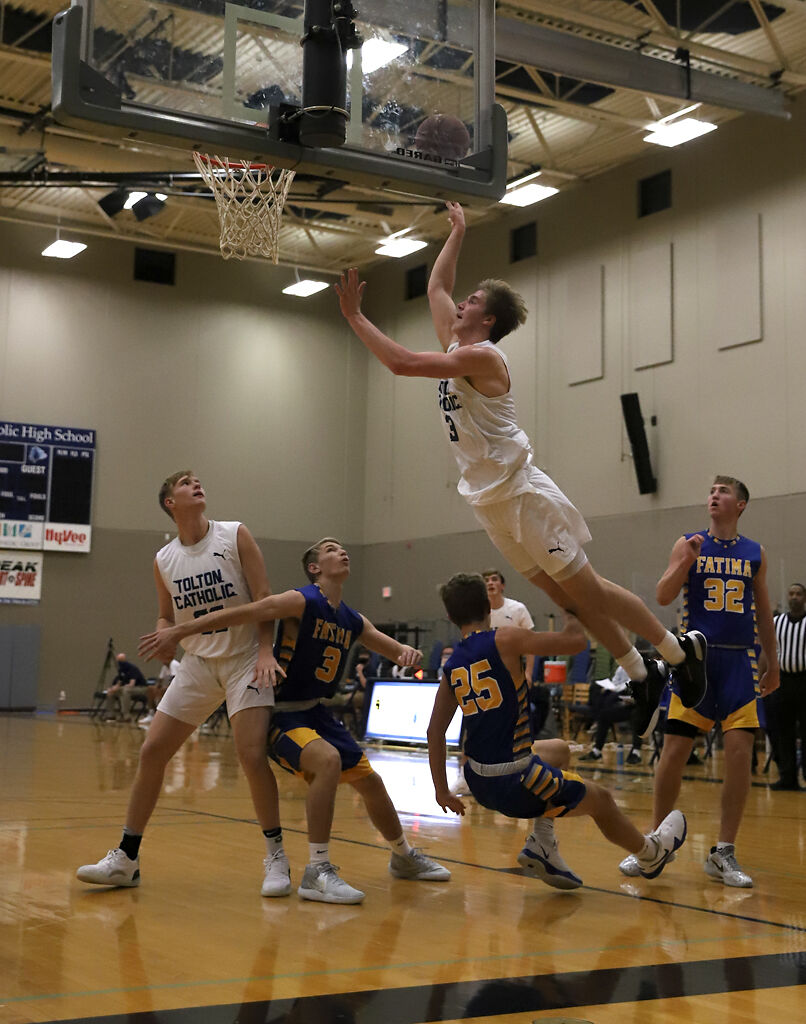Justin Boyer leaps over Cooper Kleffner to make a basket